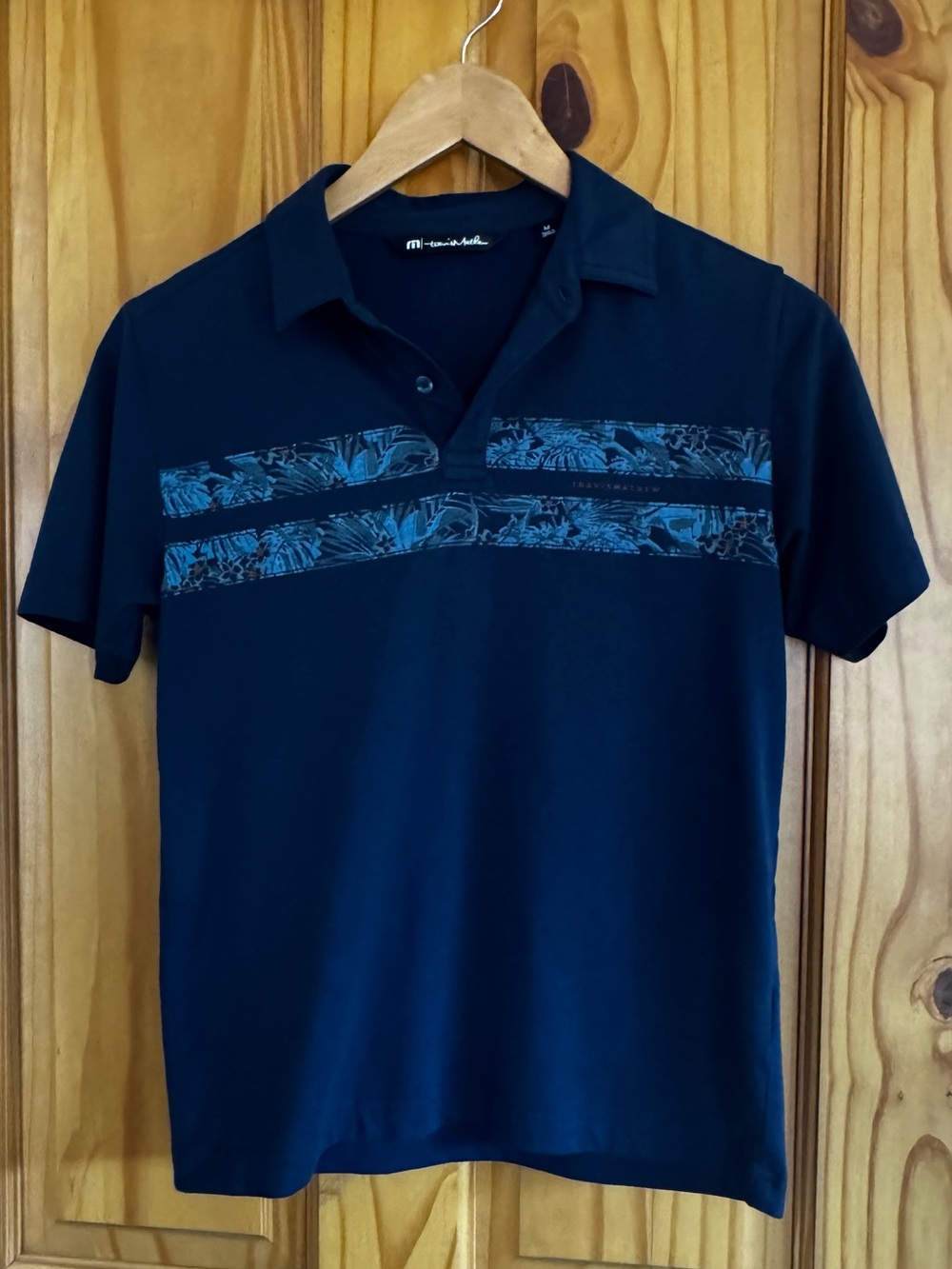 Travis Mathew Navy Polo with Blue Tropical Chest Stripes